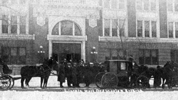 Old photo showing horse-drawn cars in front of Lincoln Hall