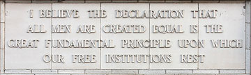 A quote in relief on the building exterior: " I believe the declaration that all men are created equal is the great fundamental principle upon which our free institutions rest."