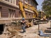 tradesman carries wooden beams