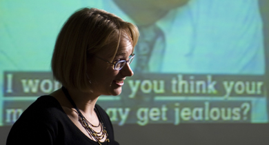 Photo of a teach using audio and visual equipment to teach.